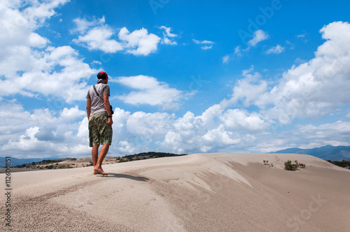 man with large backpack is traveling in the desert. Turkey