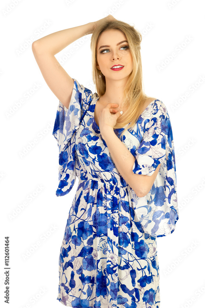 blonde posing in blue dress with a floral pattern blonde posing in blue dress with a floral pattern