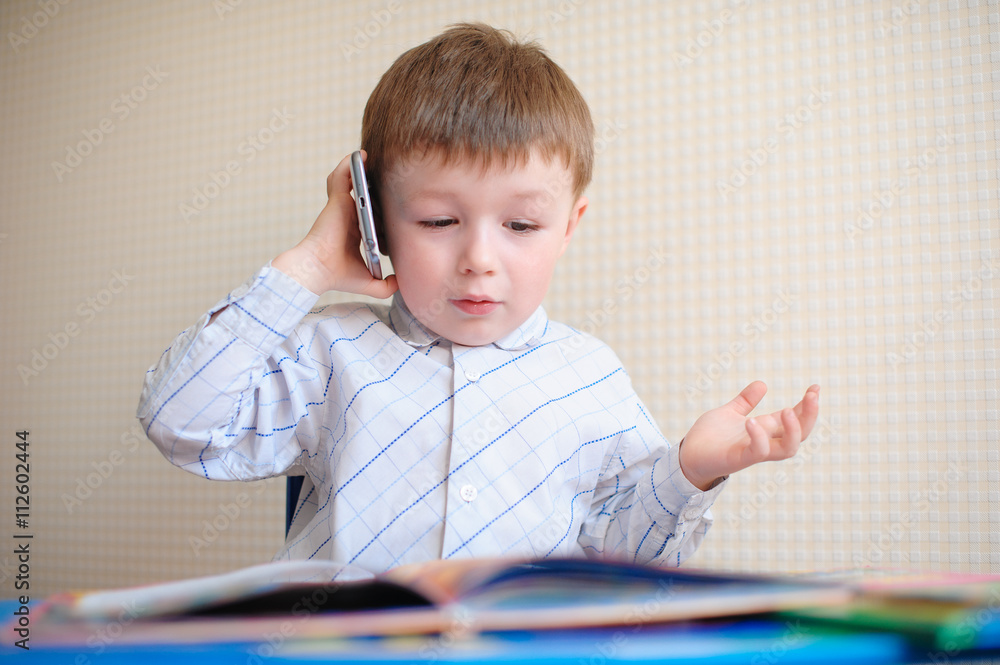 Little Boy Having a Serious Phone Call at desk Little Boy Having a Serious Phone Call at desk