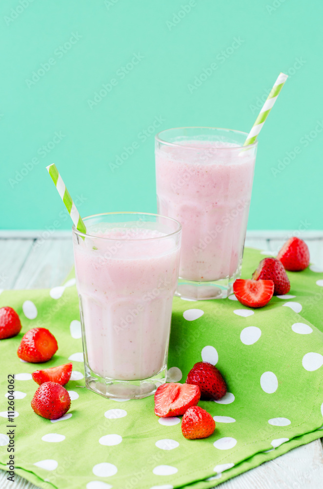 Summer refreshing cold drink , a milkshake with strawberries on a bright color background
Summer refreshing cold drink , a milkshake with strawberries on a bright color background
