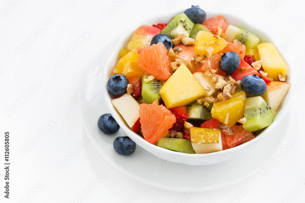 Delicious fruit salad on white table, top view