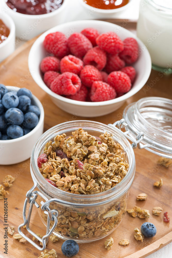 glass jar with homemade granola and berries, vertical, top view glass jar with homemade granola and berries, vertical, top view