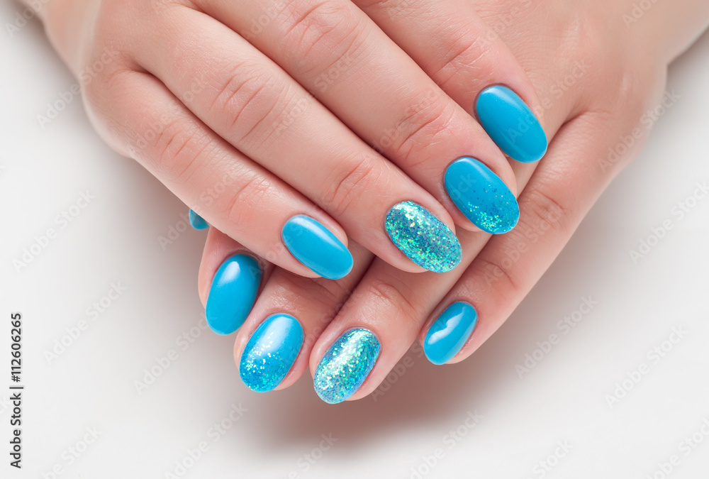 blue nail polish with glitter on the ring finger blue nail polish with glitter on the ring finger
