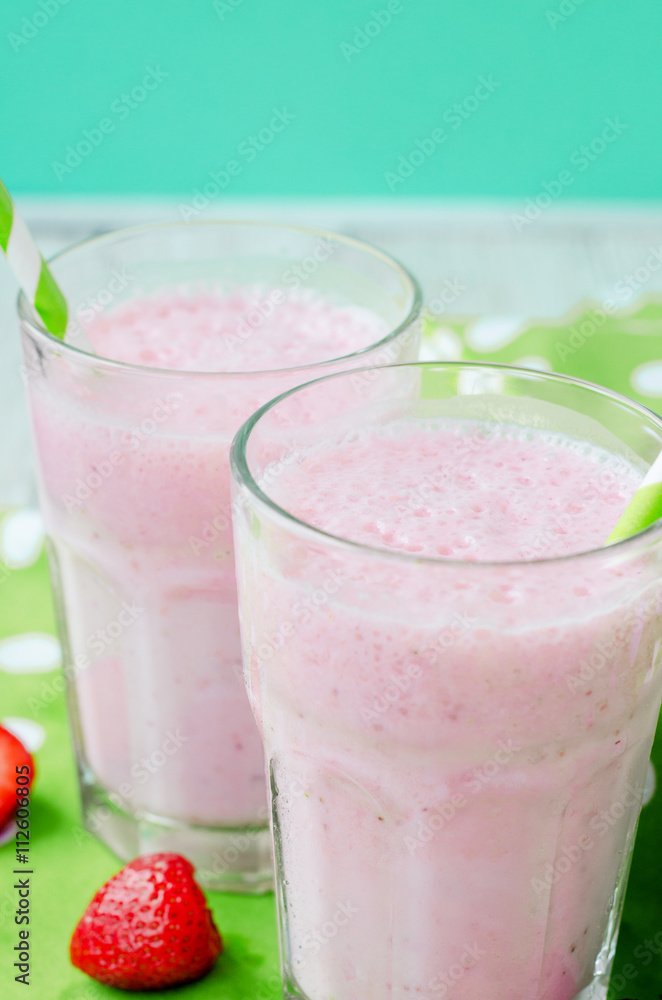 Summer refreshing cold drink , a milkshake with strawberries on a bright color background
Summer refreshing cold drink , a milkshake with strawberries on a bright color background