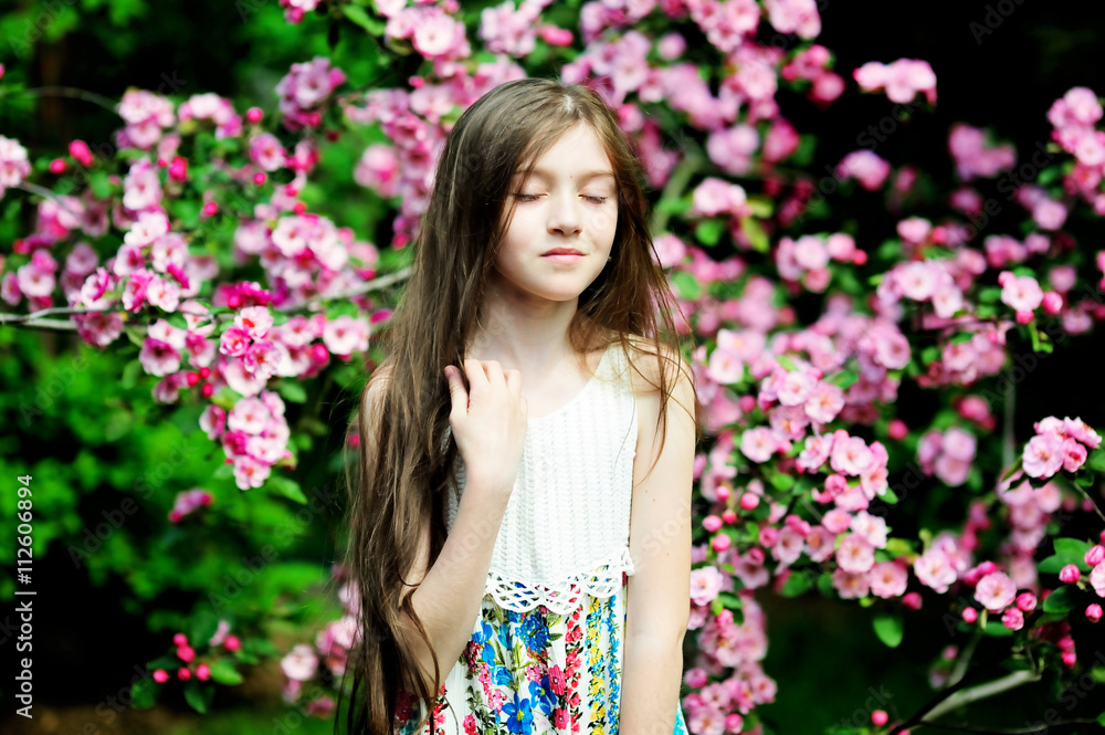 Kid girl in blooming garden Kid girl in blooming garden