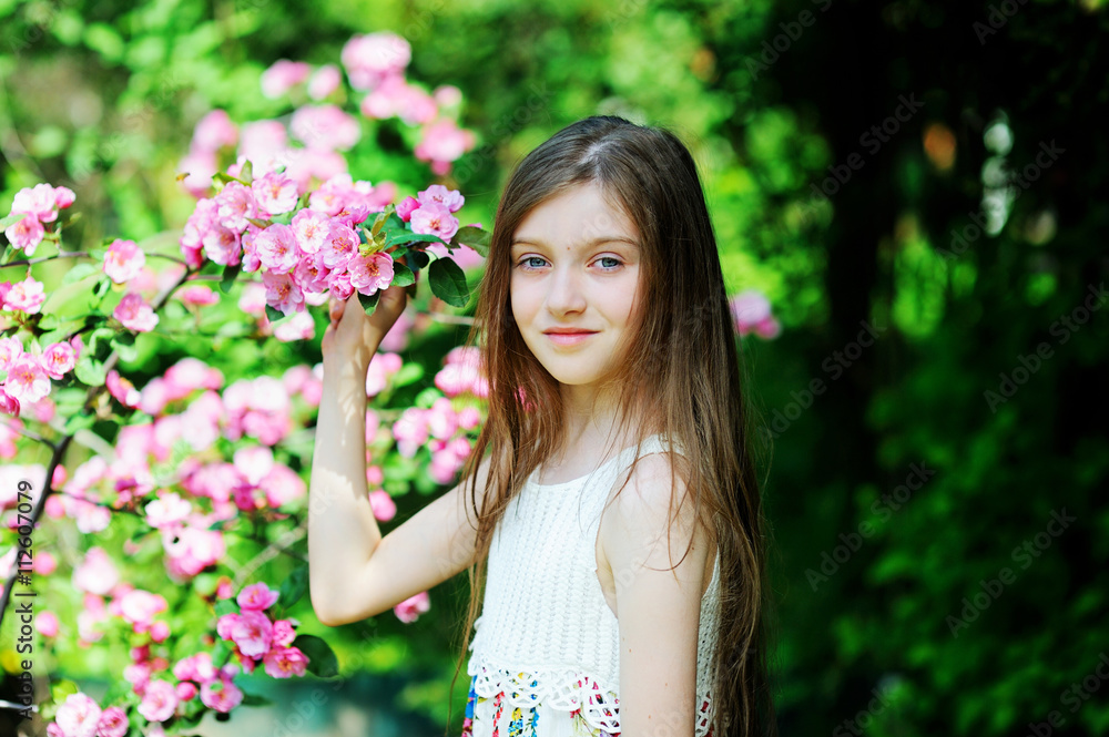 Kid girl in blooming garden Kid girl in blooming garden