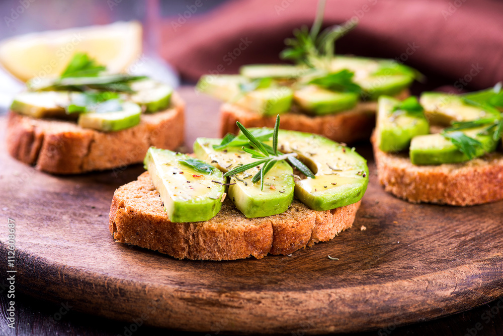 Toast with avocado, herbs on wooden board Toast with avocado, herbs on wooden board