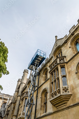 Telescopic boom lift in an old public building. Low angle view.