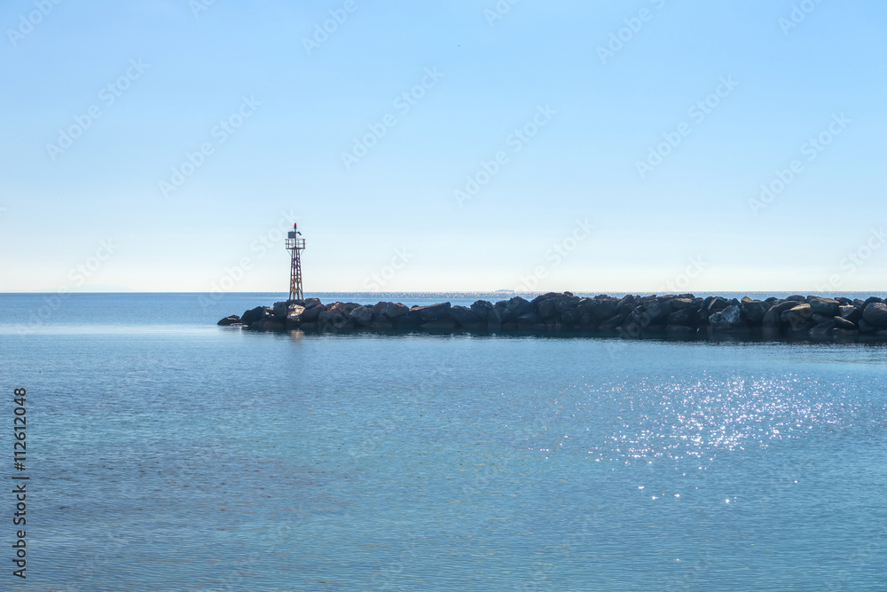 Fototapeta premium Small lighthouse in Cyclades, Greece during summer.