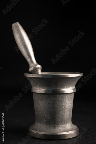Bronze ancient mortar and pestle. Most desaturated colors.