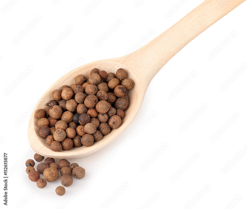wooden spoon with pimento peppercorns isolated on white backgrou wooden spoon with pimento peppercorns isolated on white backgrou