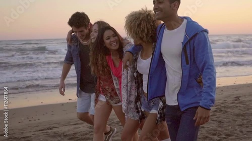 Wallpaper Mural Sexy young attractive people walking down the sandy beach in the evening and have a great time in slow motion. Torontodigital.ca