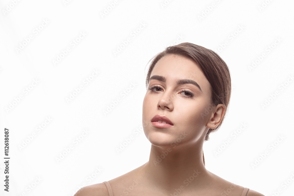 Closeup portrait of shirtless lady posing over white background. Young woman demonstrating her elegant shoulders. Closeup portrait of shirtless lady posing over white background. Young woman demonstrating her elegant shoulders.