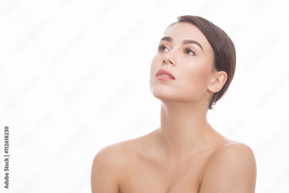 Beautiful young woman after bath with towel isolated on white background studio. Pretty lady looking in distance indoors.