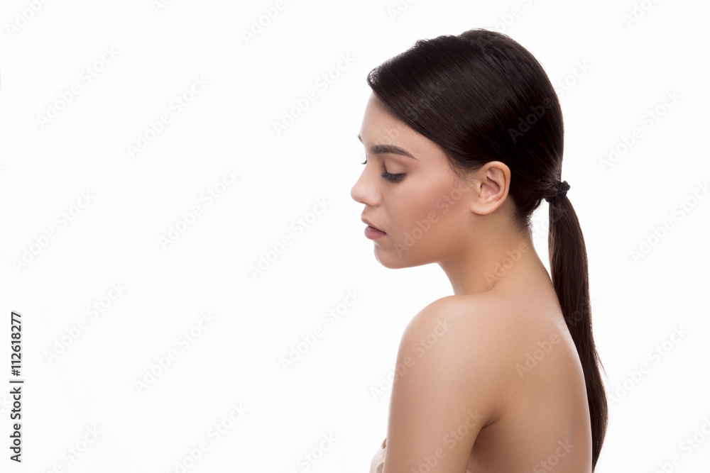 Closeup portrait of beautiful young woman posing in studio. Lady with long hair showing her elegant and gorgeous back over white background. Closeup portrait of beautiful young woman posing in studio. Lady with long hair showing her elegant and gorgeous back over white background.