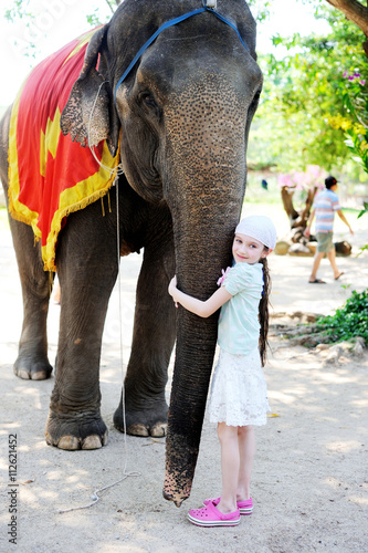 Teen girl feeding elephant