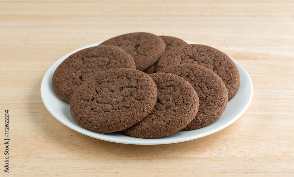 Plate of Dutch cocoa cookies on a wood table top Plate of Dutch cocoa cookies on a wood table top