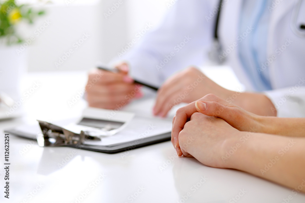Fototapeta premium Doctor and patient are discussing something, just hands at the table