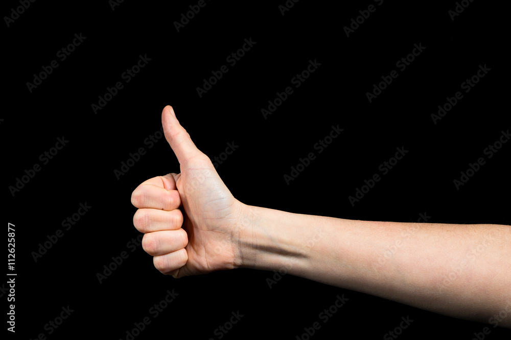 Thumb up of Caucasian female hand on black background Thumb up of Caucasian female hand on black background