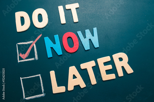 Do It Now or Later with checkbox and red check on blackboard