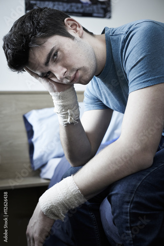 Foto Depressed Young Man With Bandaged Wrists After Suicide Attempt