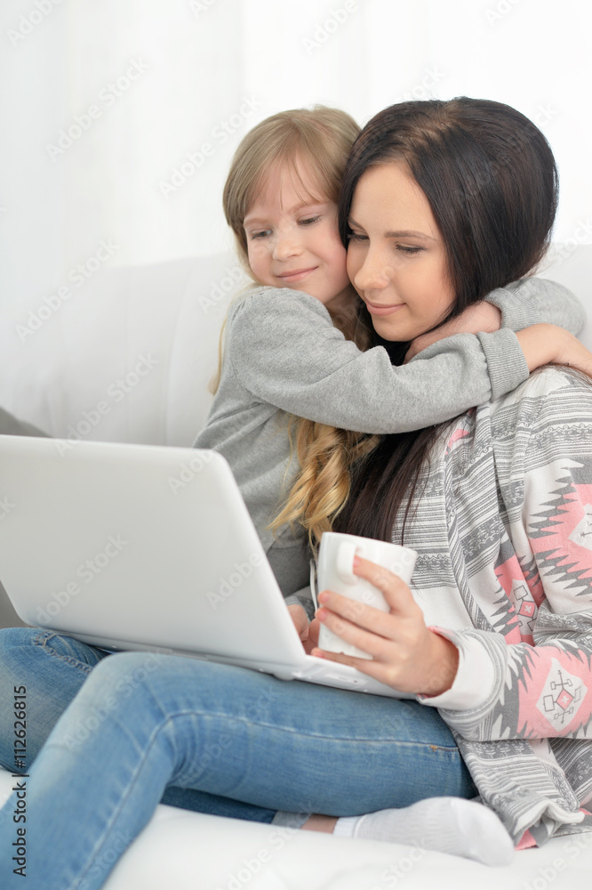 mother and daughter using laptop mother and daughter using laptop