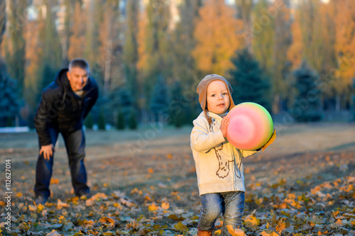 cheerful kid with an apple in the fall