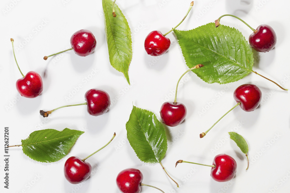 Composition of ripe cherries with leaves. Top view. Composition of ripe cherries with leaves. Top view.