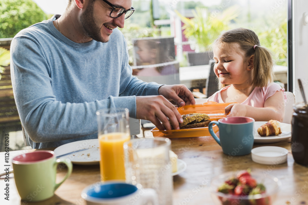 Father and daughter having breakfast together Father and daughter having breakfast together