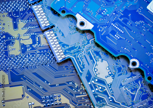 Canvas Print Circuit board close-up picture. Blue industrial background.