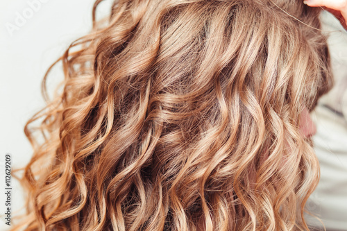 close-up of curly blond hair in barber beauty salon