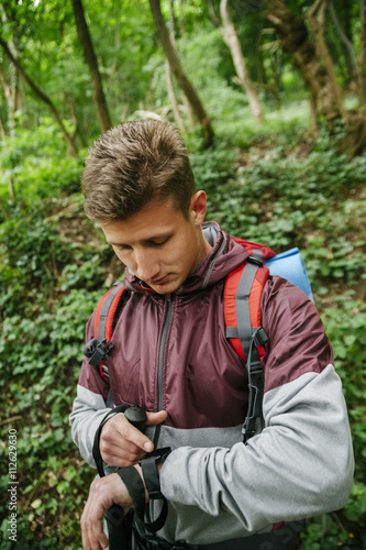 Serbia, Rakovac, young hiker looking at smartwatch photo