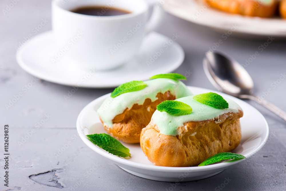 Breakfast with mint eclairs and cup of coffee Breakfast with mint eclairs and cup of coffee