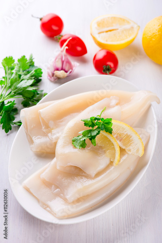 Wallpaper Mural Raw squid and ingredients on the white plate Torontodigital.ca