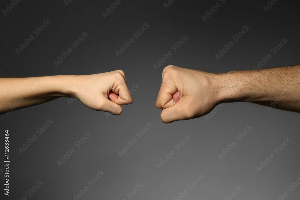 Man and woman fists on grey background Man and woman fists on grey background