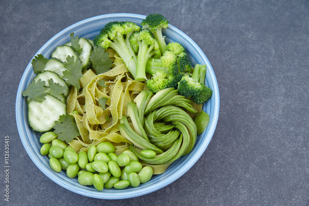 Vegetarian pasta with cucumber, broccoli, avocado and edamame