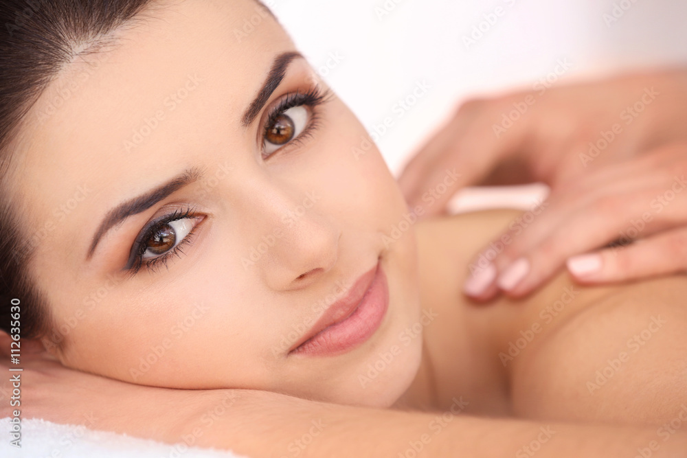 Young woman having massage in spa salon