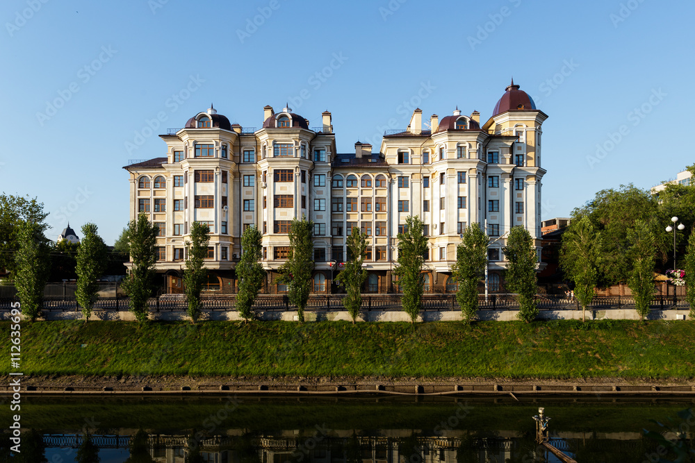new modern house on the embankment with green grass and trees in Kazan Russia.