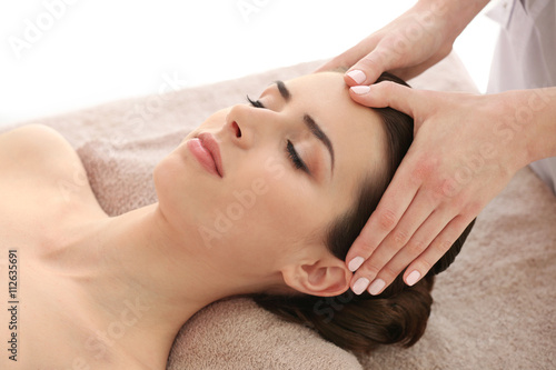 Young woman having massage in spa salon