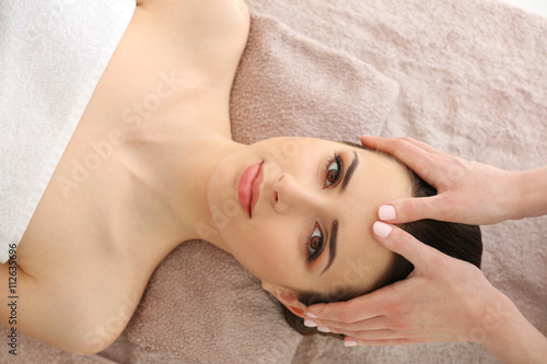 Young woman having massage in spa salon