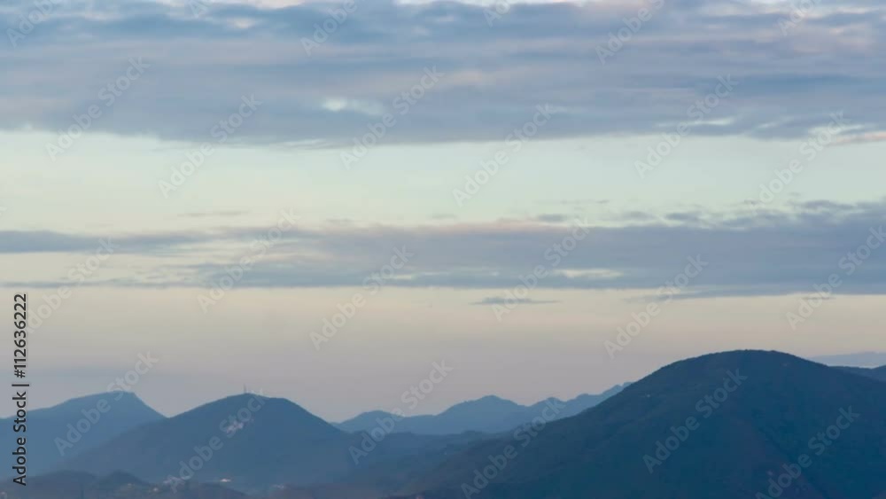 time lapse of clouds pacing in the sky over mountains in blue morning fog just before sunrise time lapse of clouds pacing in the sky over mountains in blue morning fog just before sunrise