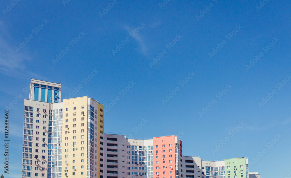 high rise residential building and bright color sky with copy space