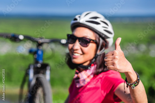 Cyclist Woman Showing Thumb Up gesture, Outdoor © EdNurg