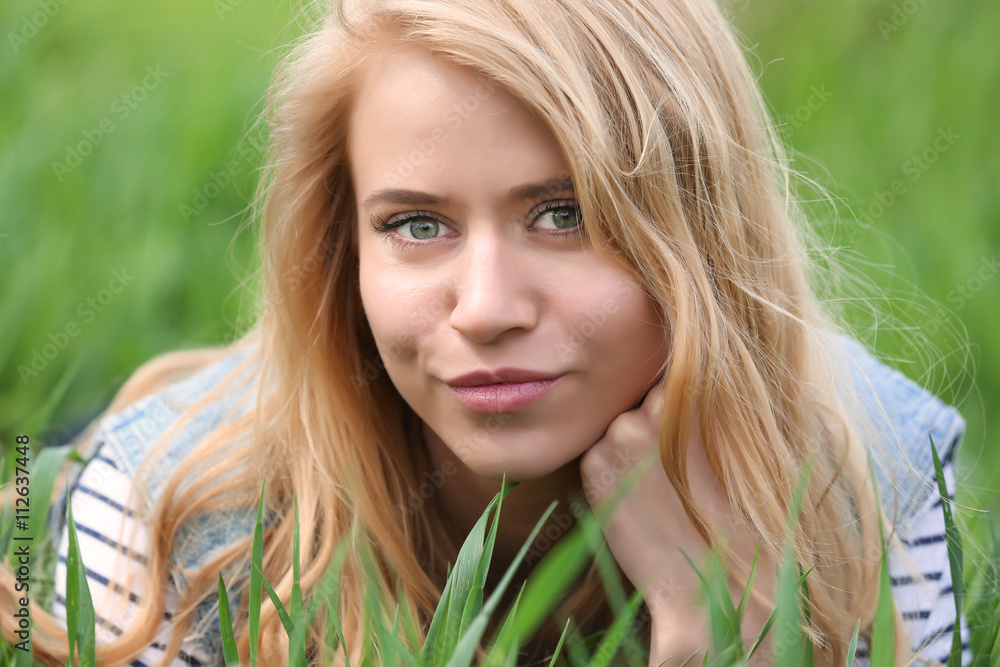 Young beautiful woman on green grass Young beautiful woman on green grass