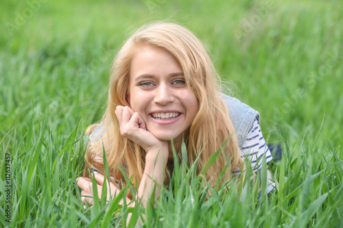 Young beautiful woman on green grass