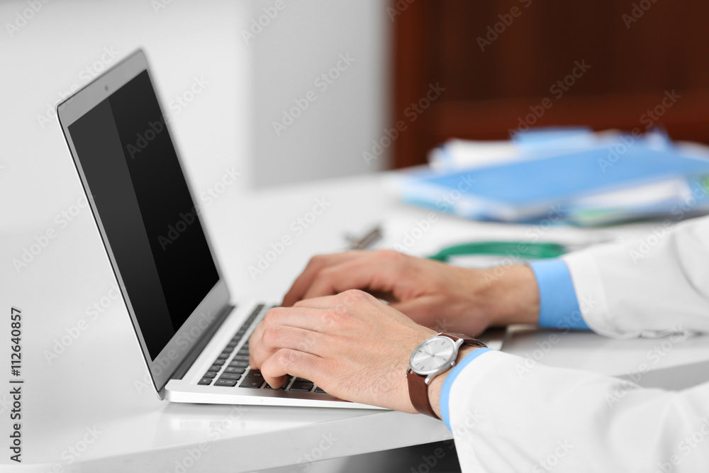 Doctor working on a computer in hospital Doctor working on a computer in hospital