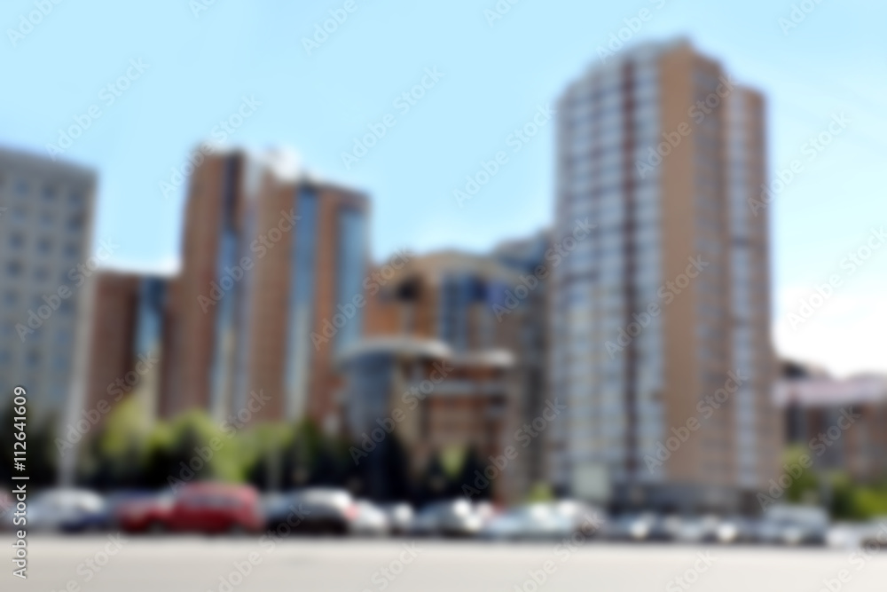 View on the street with buildings and cars, unfocused