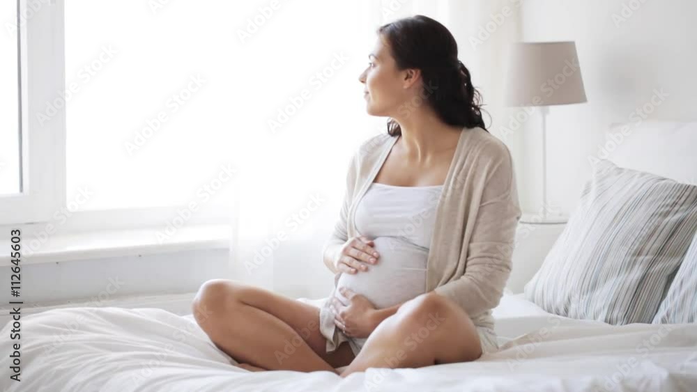 happy pregnant woman touching her tummy at home 11 happy pregnant woman touching her tummy at home 11