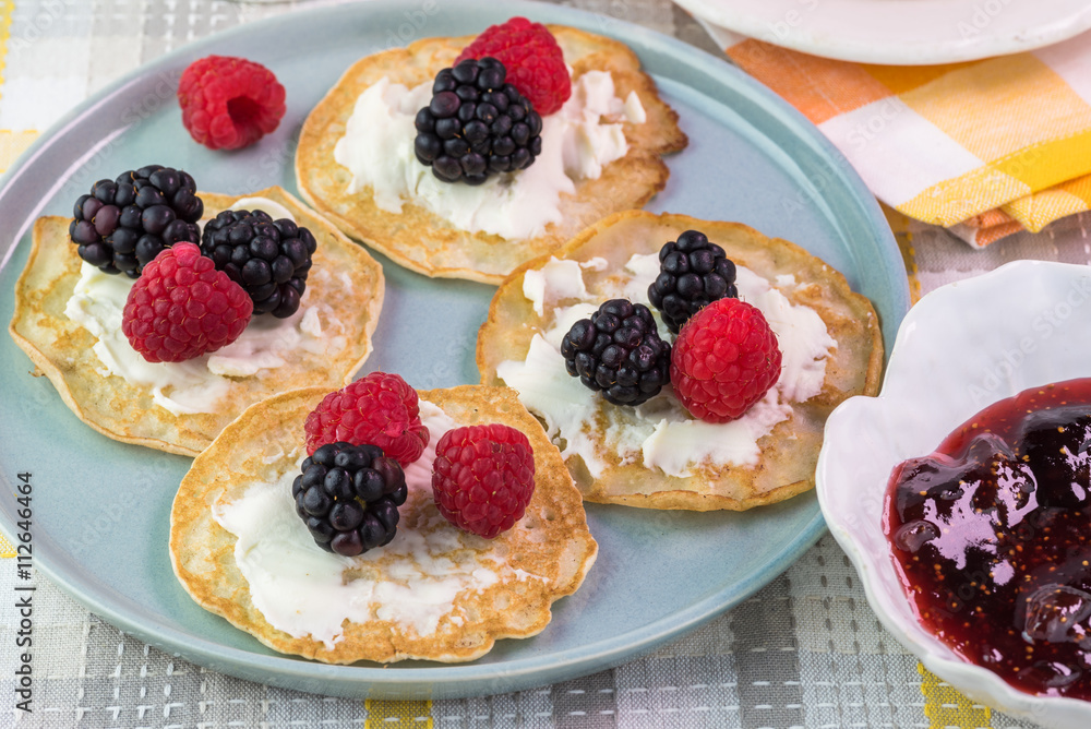 Cornmeal cakes garnish with fresh berries and bowl of berry fig Cornmeal cakes garnish with fresh berries and bowl of berry fig