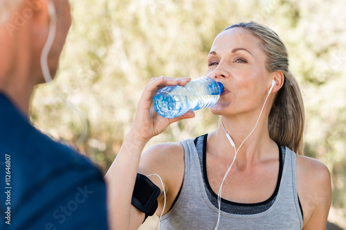 Atlethic woman drinking water